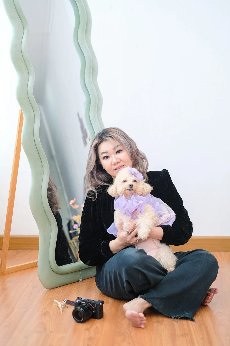 Owner holding her dog beside a mirror