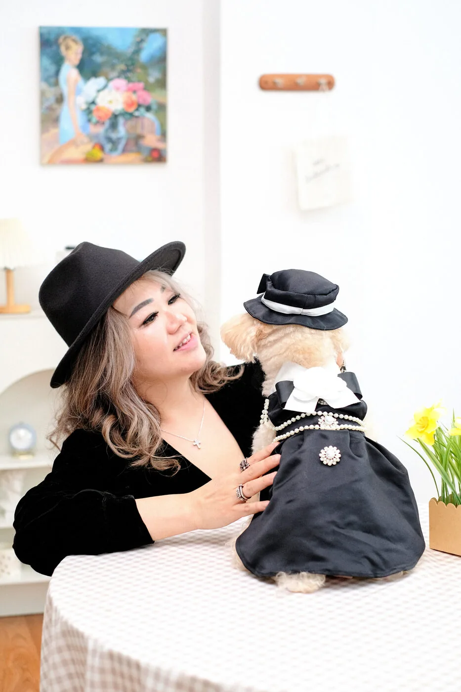 Owner with her dressed-up dog at a table